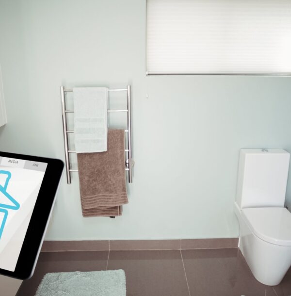 Digital composite of Hand using smart home application on digital tablet in washroom